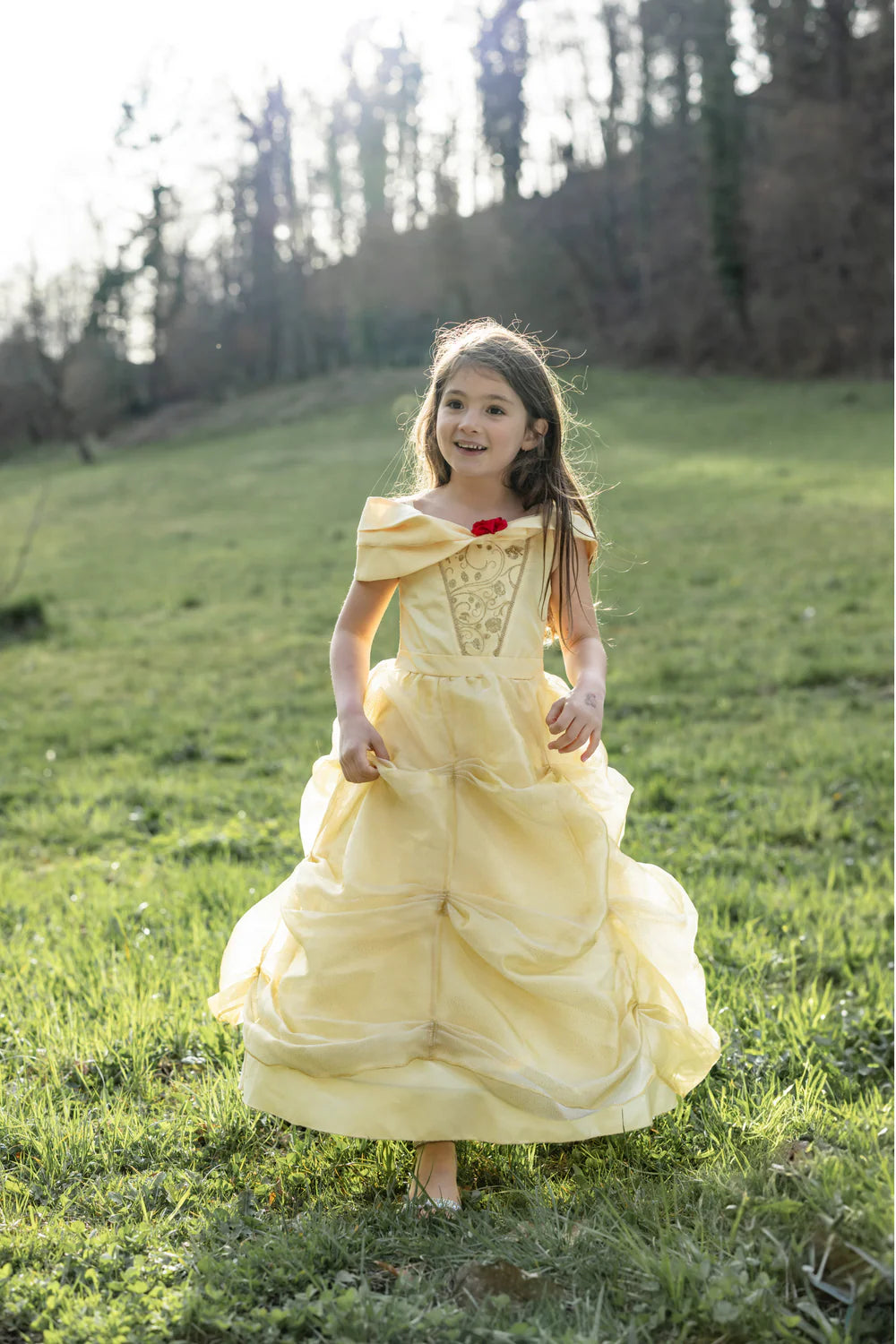 Full image of dress shows long ankle length yellow skirt with large ruffles.