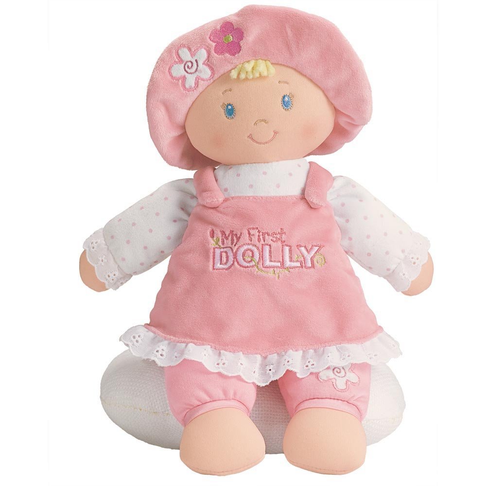 A blonde stuffed doll with a pink embroidered dress and floppy hat, smiling and seated.