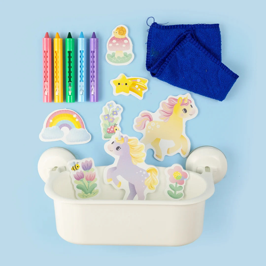 Unicorn-themed coloring set with markers, stickers, and a cloth on a blue background