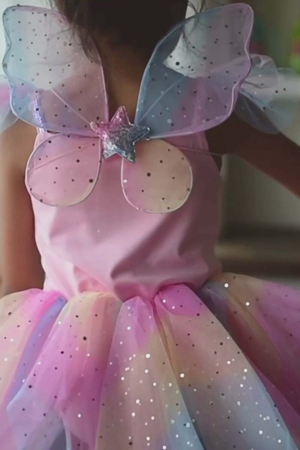 Fairy wings on back of costume have sparkles and a shimmery star in the middle.