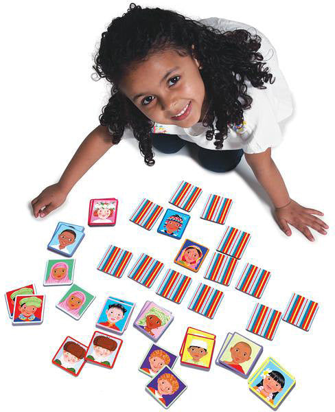 young girl smiling with cards from "i never forget a face" game