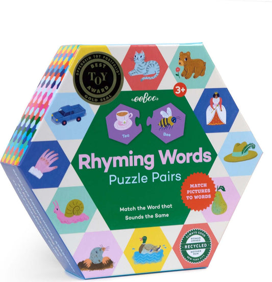 A boxed set of Rhyming Words Puzzle Pairs featuring colorful hexagonal pieces with illustrations and text, designed for children aged 3+.