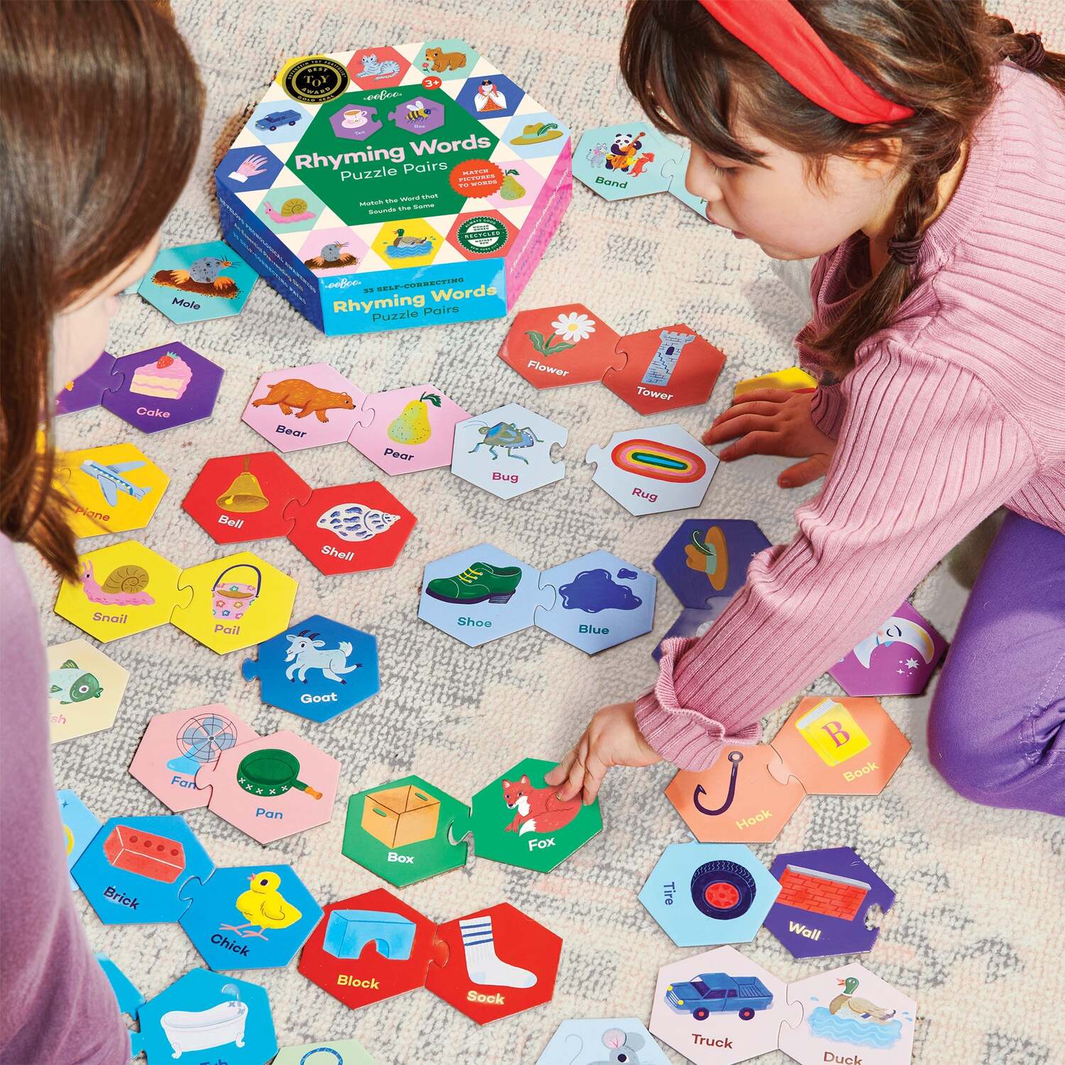 children playingnwith hexagon puzzle pairs on floor