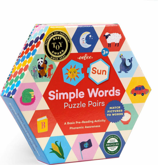 A box of Simple Words Hexagon puzzle pairs featuring colorful illustrations of objects and animals on hexagon-shaped puzzle pieces, with the product label indicating it is for ages 3+ and includes 33 hexagon shaped puzzle pairs.