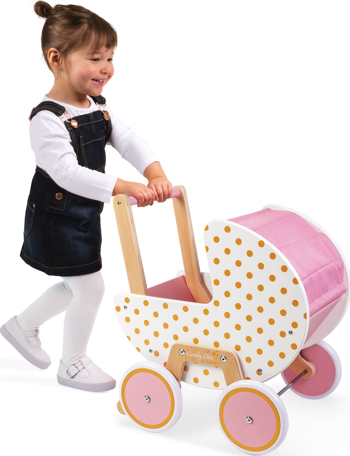 little girl pushing pink doll pram and smiling
