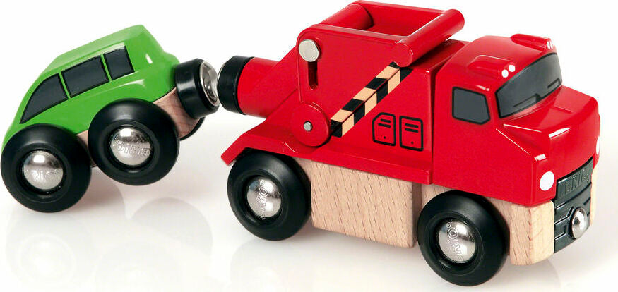 closer image of tow truck attached to a small green car by a magnet