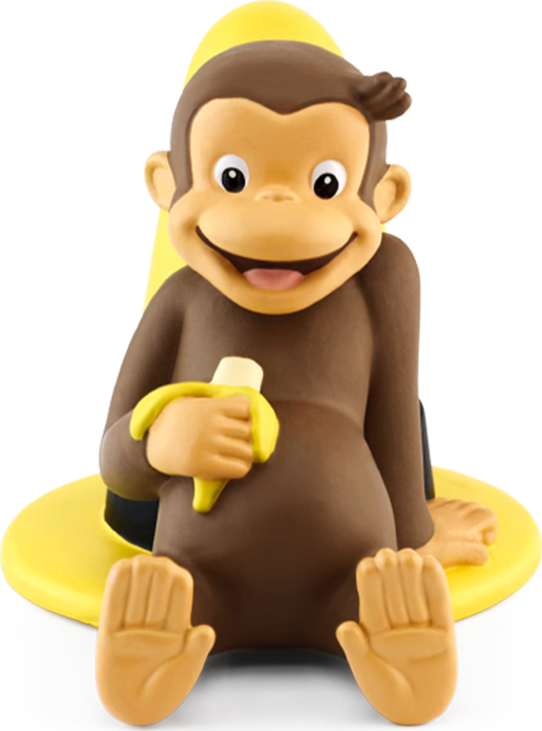 Curious George figurine holding a banana, seated on a yellow hat .