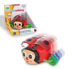 A colorful electronic ladybug toy shown next to its retail packaging box. The toy features a red and black ladybug shell with a smiling face, a green antenna, and rainbow-colored wheels.