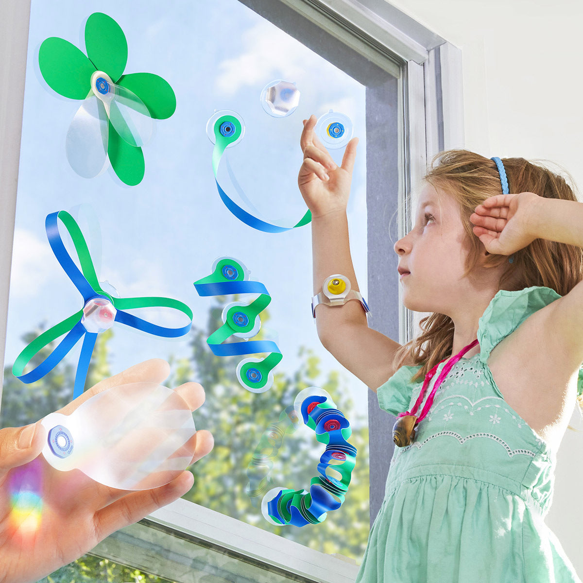 Child interacting with colorful butterfly window stickers on a glass door.