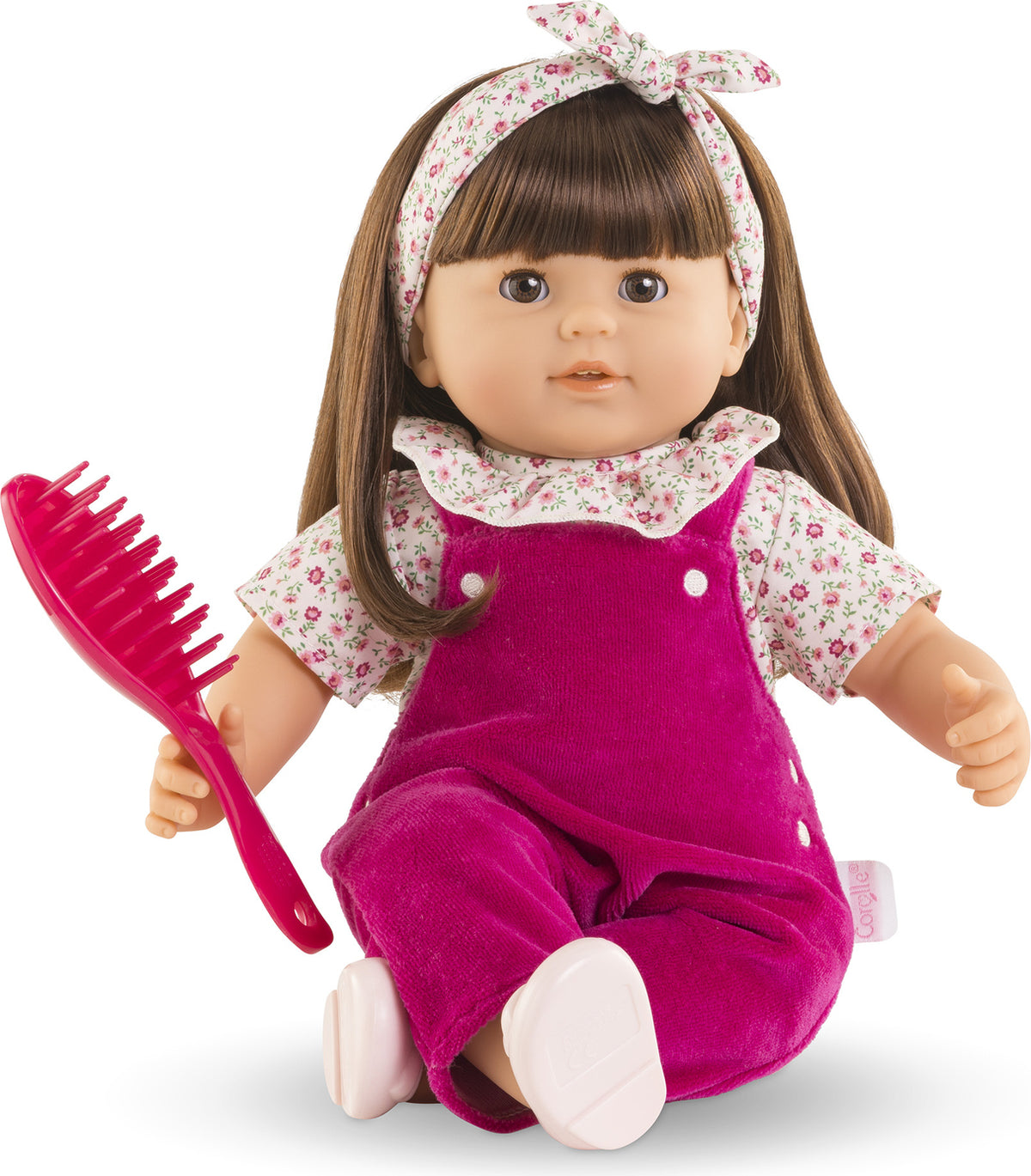 Julie - Pink Grenadine
14 inch brunette doll wearing floral shirt and magenta corduroy overalls. Comes with hair brush and floral headband.