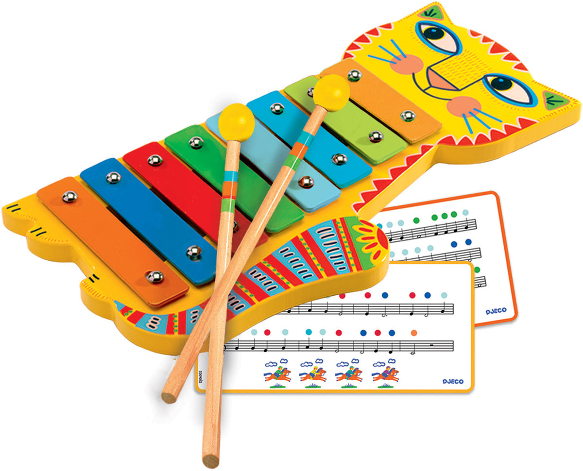 A colorful metallophone with cat-inspired artwork, designed by Magali Attiogbe. It includes 8 metal bars on a wood base, two wooden mallets, and music cards for 4 songs.