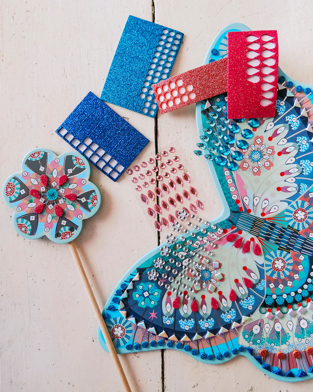 Decorative fans with intricate patterns on a light wooden surface