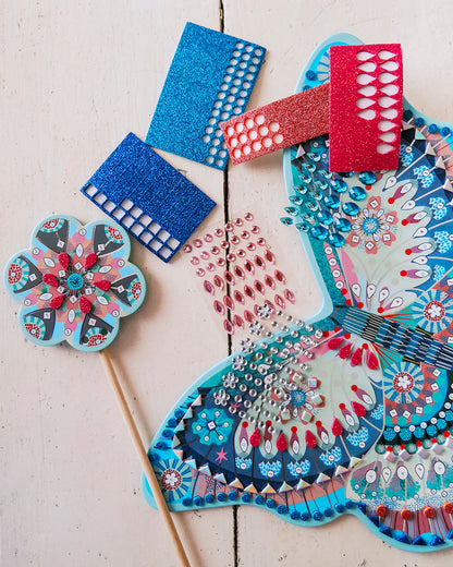 Decorative fans with intricate patterns on a light wooden surface