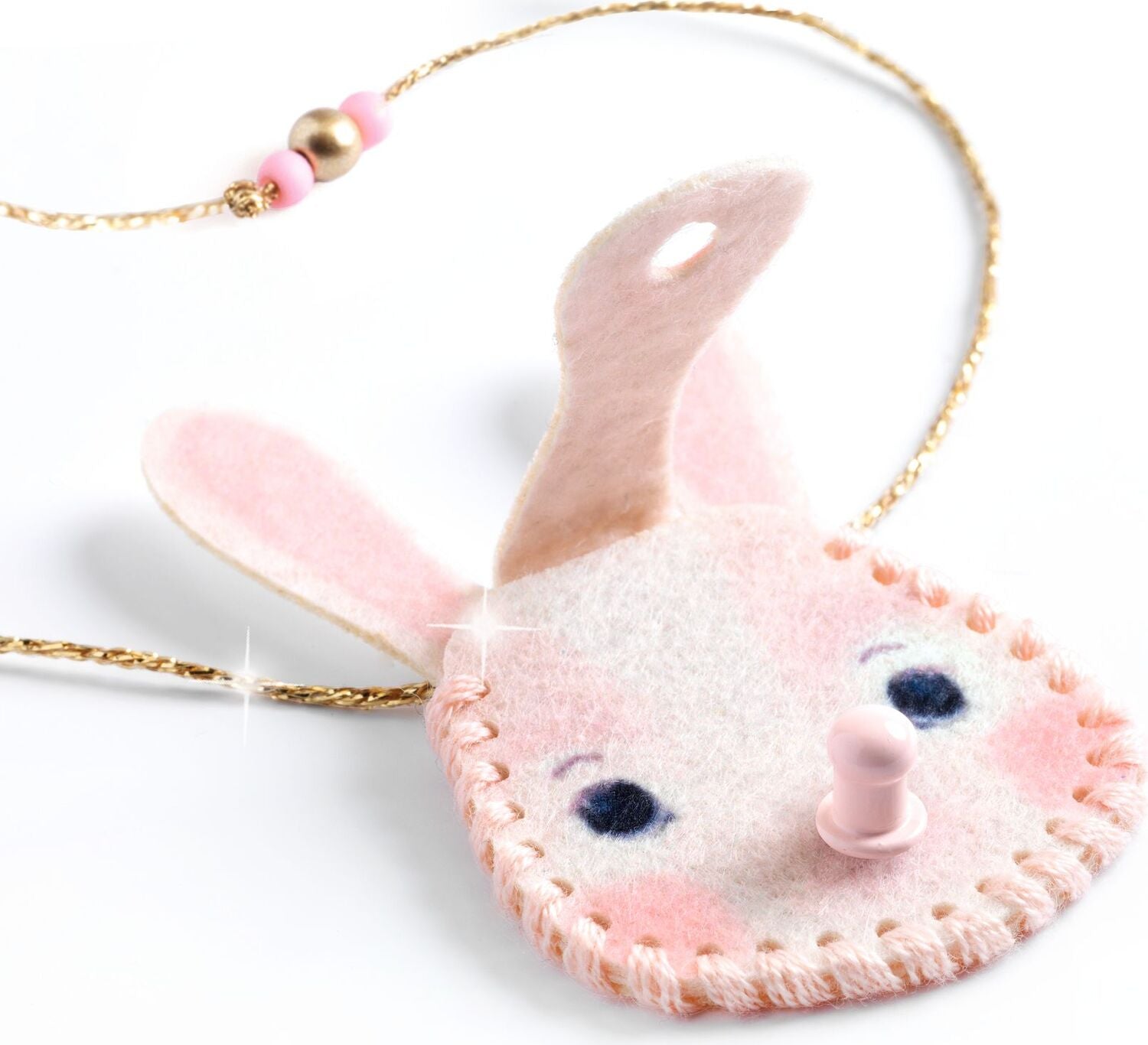 A pink felt bunny-shaped pendant necklace with embroidered details, a gold-tone chain, and pink and gold beads, shown on a white background.