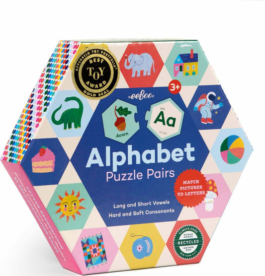 A box of Alphabet Hexagon puzzles featuring colorful hexagon-shaped puzzle pieces with letters and images on them, labeled for ages 3+.