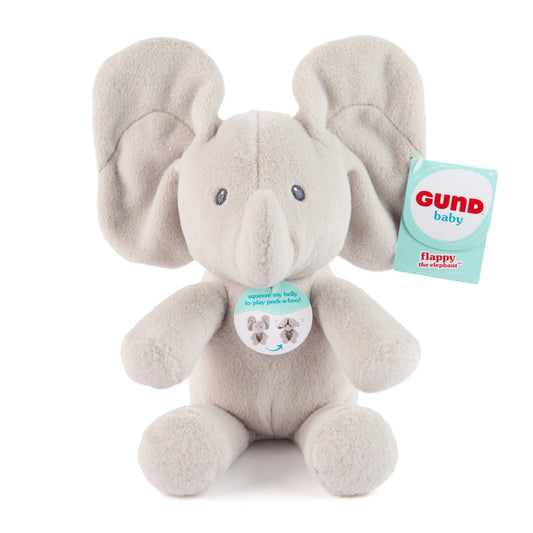 Plush elephant toy with a tag on a white background