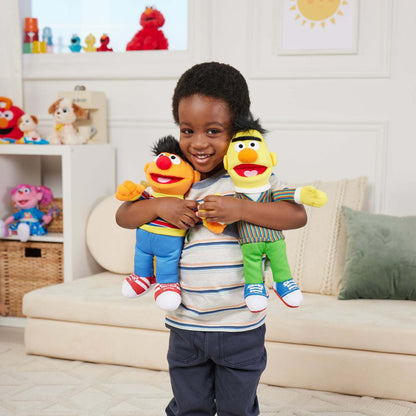 child hugging 2 plush Ernie and Bert from sesame street.