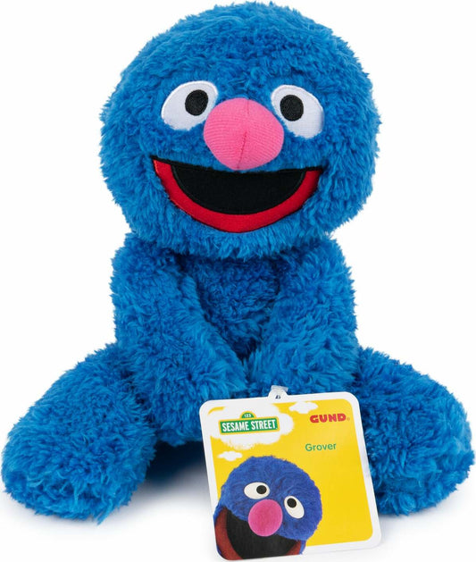 A plush toy of Grover from Sesame Street, which is blue with a floppy hat, smiling face, and soft texture.