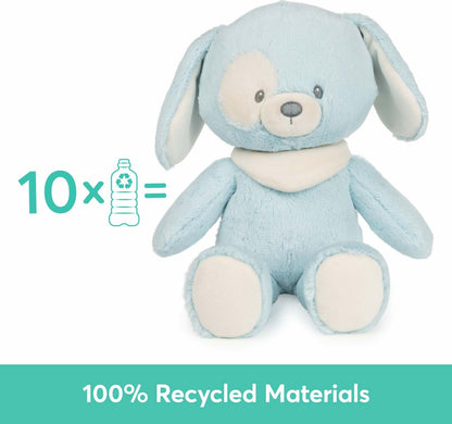A light sky-blue plush puppy toy sits upright against a white background, To its left, light blue text reads "10x" next to a plastic bottle, A teal banner across the bottom states "100% Recycled Materials".