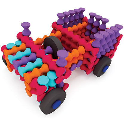 Colorful toy truck made of interlocking pieces on a white background