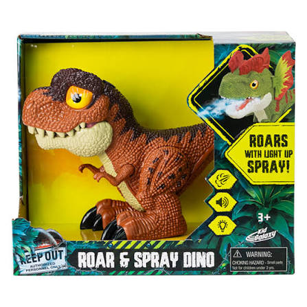 A toy dinosaur in retail packaging labeled 'Roar & Spray Dino' with text indicating it roars with light-up spray. The box shows a brown and black T-rex style dinosaur with yellow eyes and claws, set against a bright yellow window background.