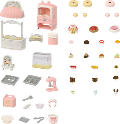 A collection of miniature toy bakery accessories against a white background, including a pink shop awning, a pink oven cabinet, display cases, baking trays, kitchen utensils, and an assortment of tiny pretend cakes, pastries, and cake toppings.