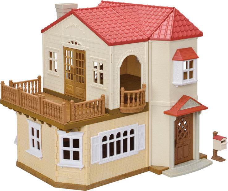 Toy house with a red roof and beige body on a white background