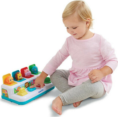 A toddler excitedly pressing one of the colorful buttons on the Kidoozie Pop 'n Play Animal Friends toy to reveal a hidden animal friend.