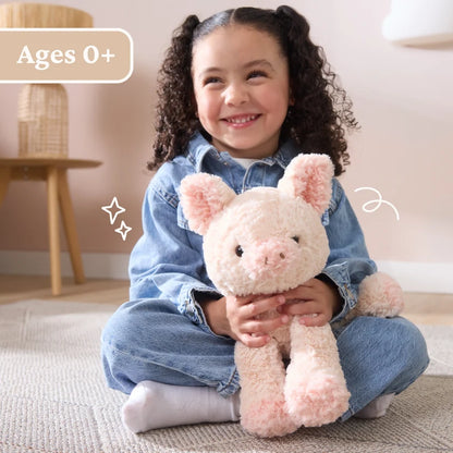 Child holding a plush toy with 'Ages 0+' label