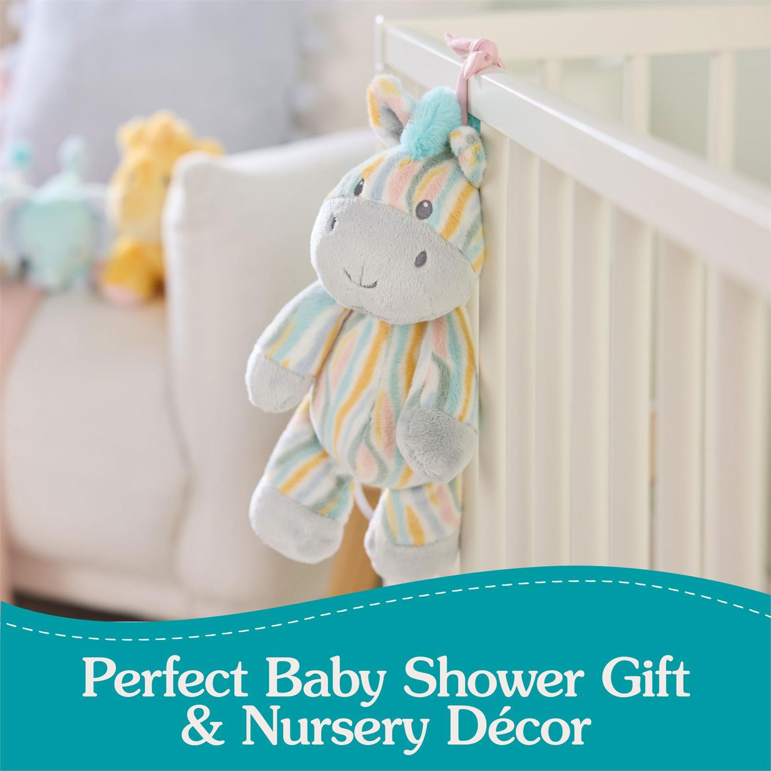 Plush toy zebra hanging from a crib with text 'Perfect Baby Shower Gift & Nursery Décor' on a teal banner.