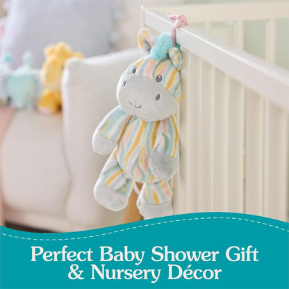 Plush toy zebra hanging from a crib with text 'Perfect Baby Shower Gift & Nursery Décor' on a teal banner.