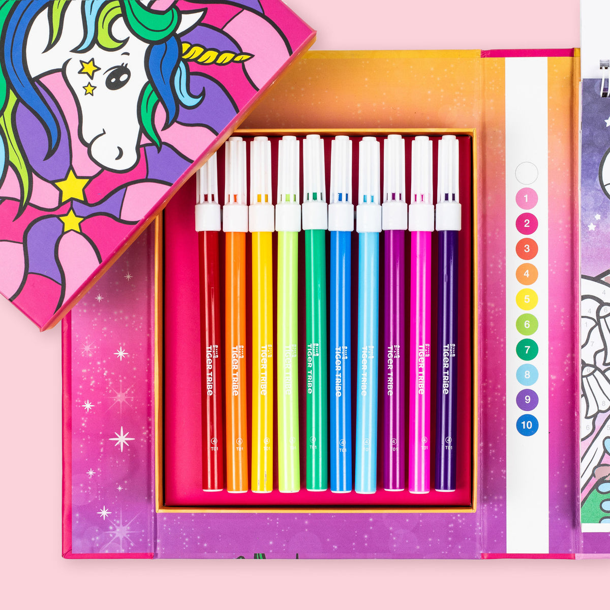 Set of colorful markers in a pink box with a unicorn design on a pink background