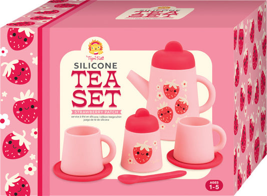 TigerTurtle brand Strawberry Patch silicone tea set in its retail packaging. The pink box features illustrations of strawberries and displays a set including a teapot, two cups, a small container, and a spoon.