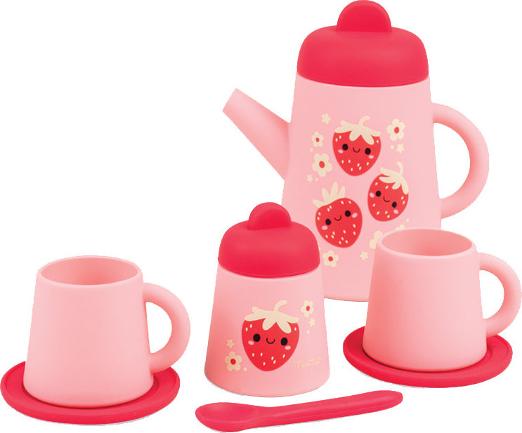 A pink children's tea or coffee set with a teapot, two mugs on saucers, a small container with a lid, and a spoon, all decorated with cute red strawberries and white flowers on a white background.