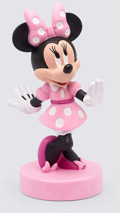 A figurine of Minnie Mouse in pink attire with a bow, standing on a round pink base.