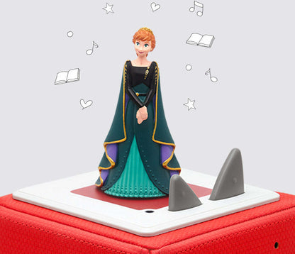 anna Toy figure of a princess in a green dress with red and white base on a light gray background