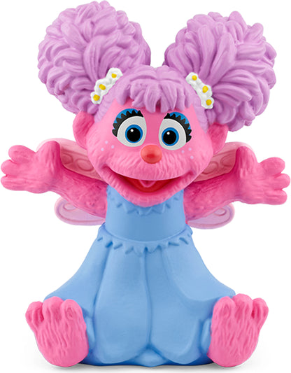 Abby Cadabby figurine with pink hair and blue outfit, sitting with arms open