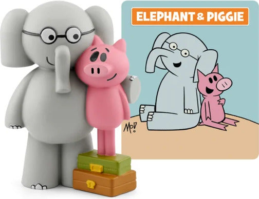 Toy figures of an elephant and a pig with a coloring book on a white background