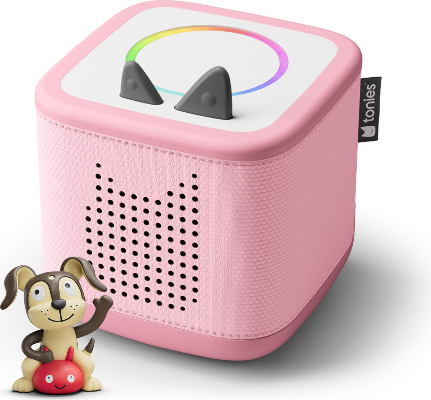 Pink toy speaker with rainbow design and dog figurine on a white background